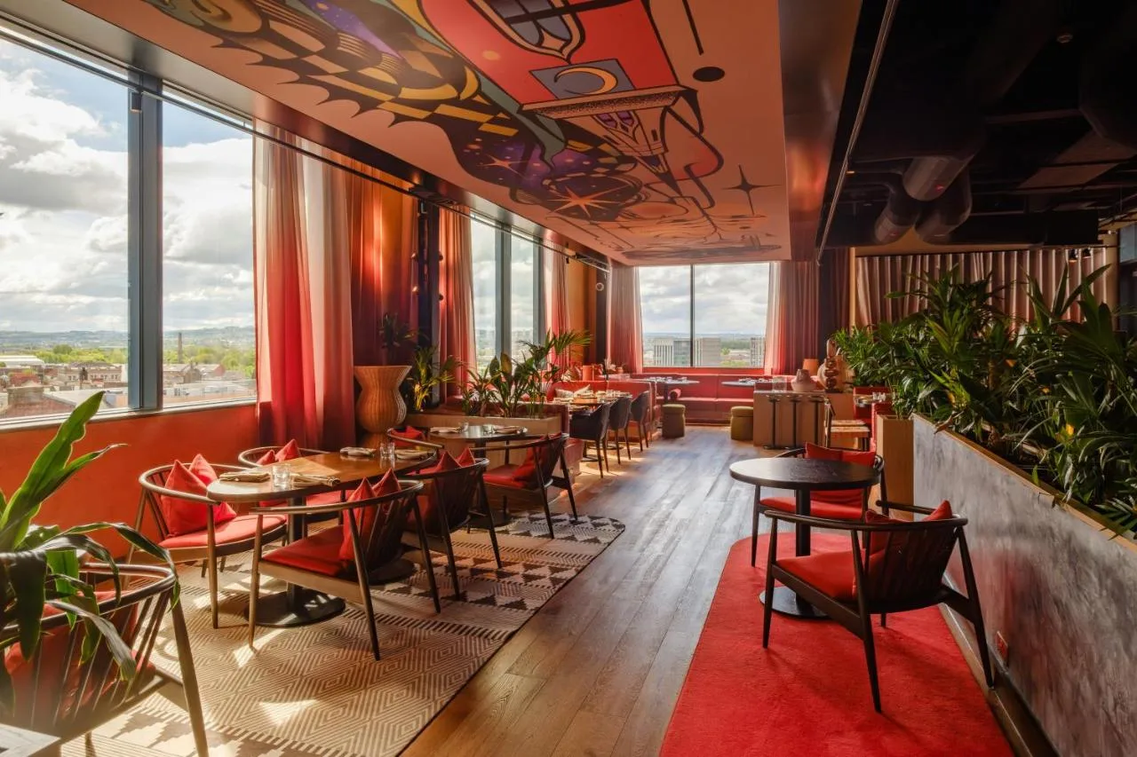 Restaurant with tables and large windows at The Social Hub Glasgow
